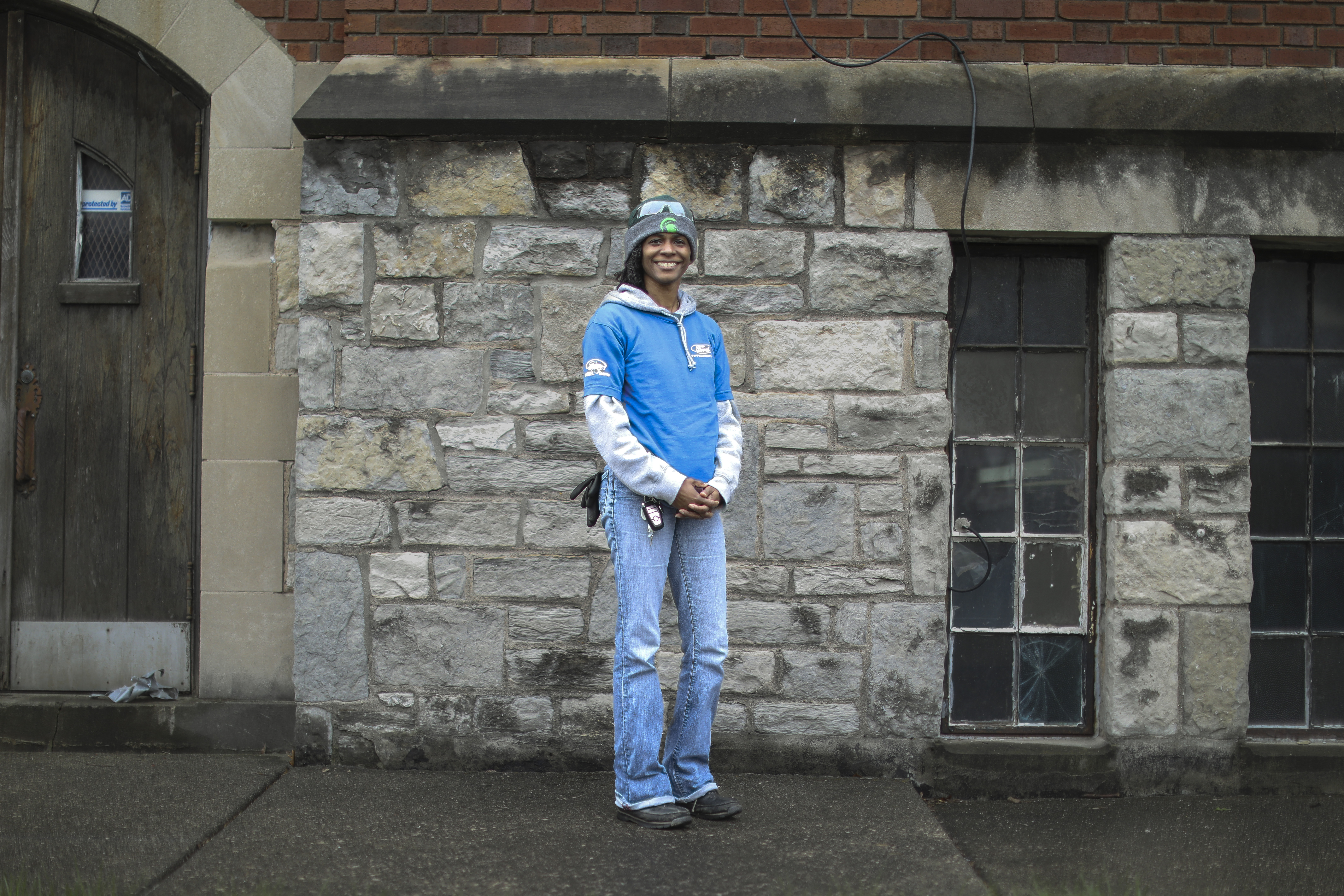 A woman in work gear poses for a photo.